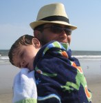 Father and son, nap time, at the beach